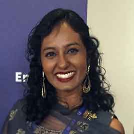 Dr Shaz Sivanesan wearing a sari, smiling at the camera.