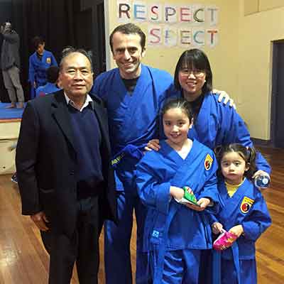 Dr Tu Le and her family wearing blue martial arts robes.